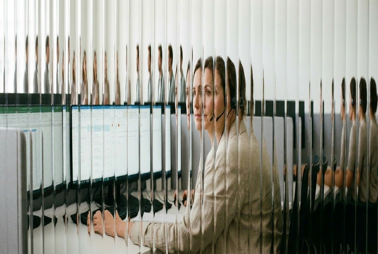 Agent in a headset at monitors of account records, the collector who takes disputes and hardship after AI works a client's collections queue