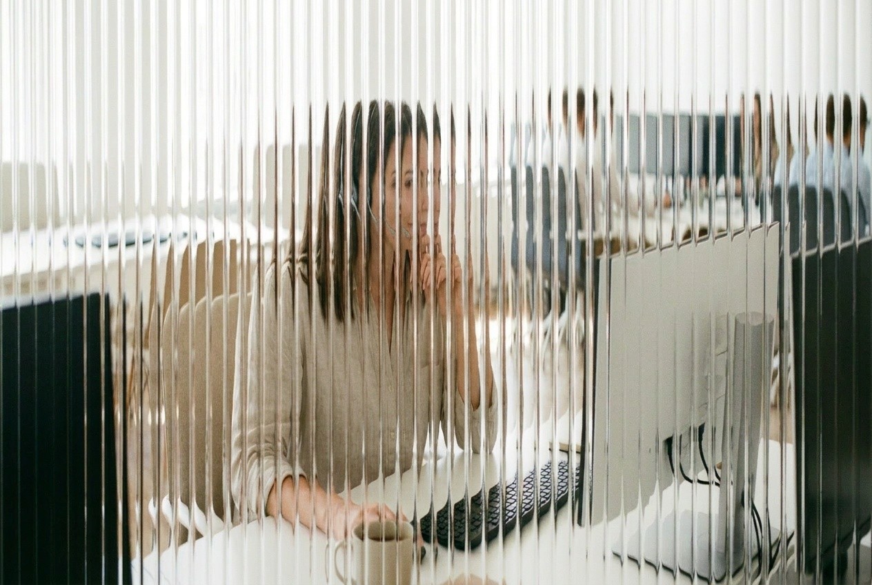 Agent at a desktop monitor working an account queue, here standing for past-due telecom accounts called before their suspension date